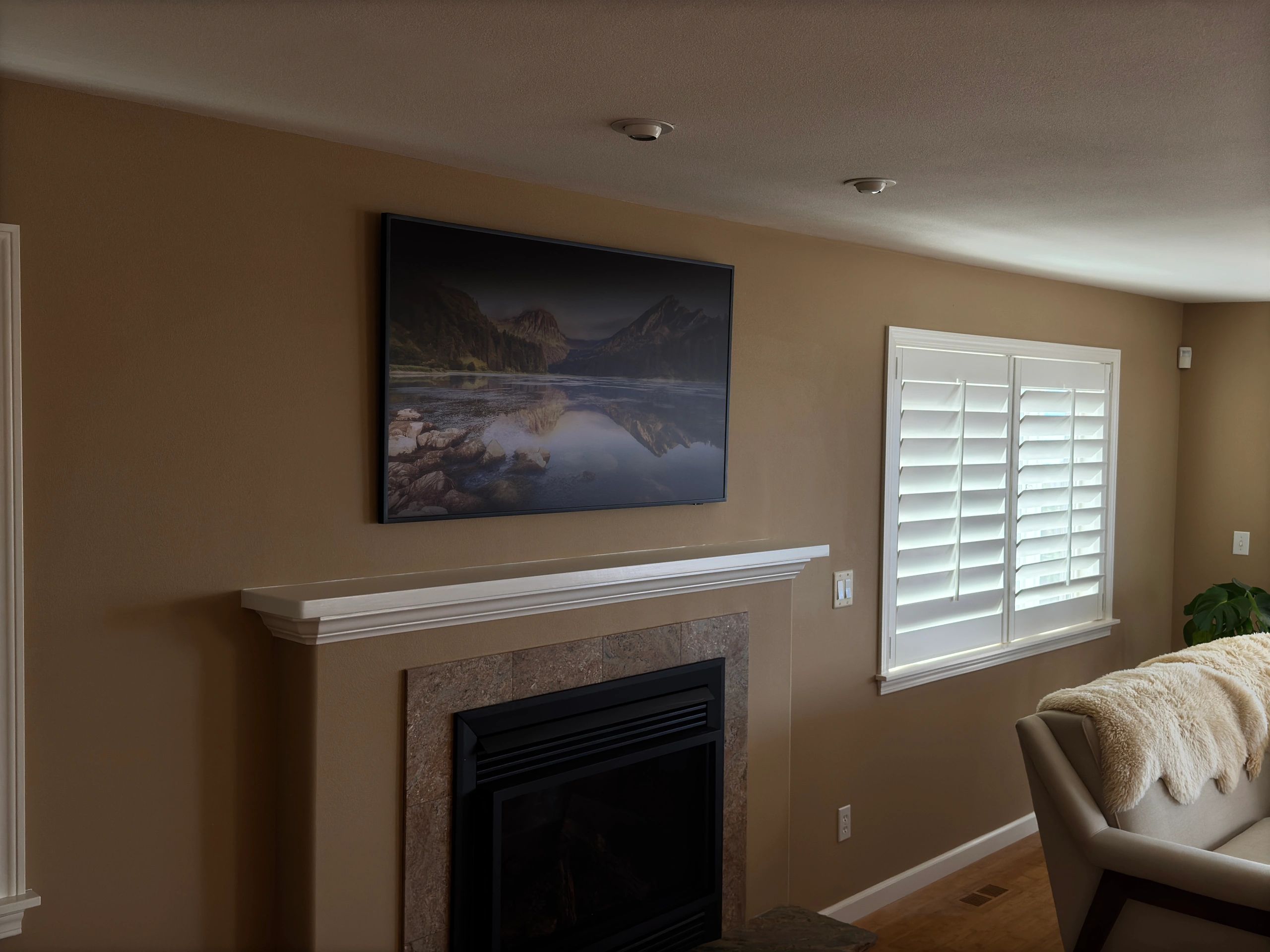 TV mounted above fireplace in living room